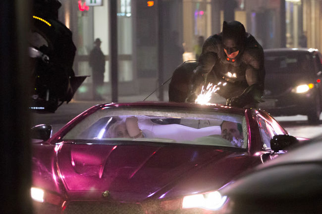 Batman rides Jokermobile 